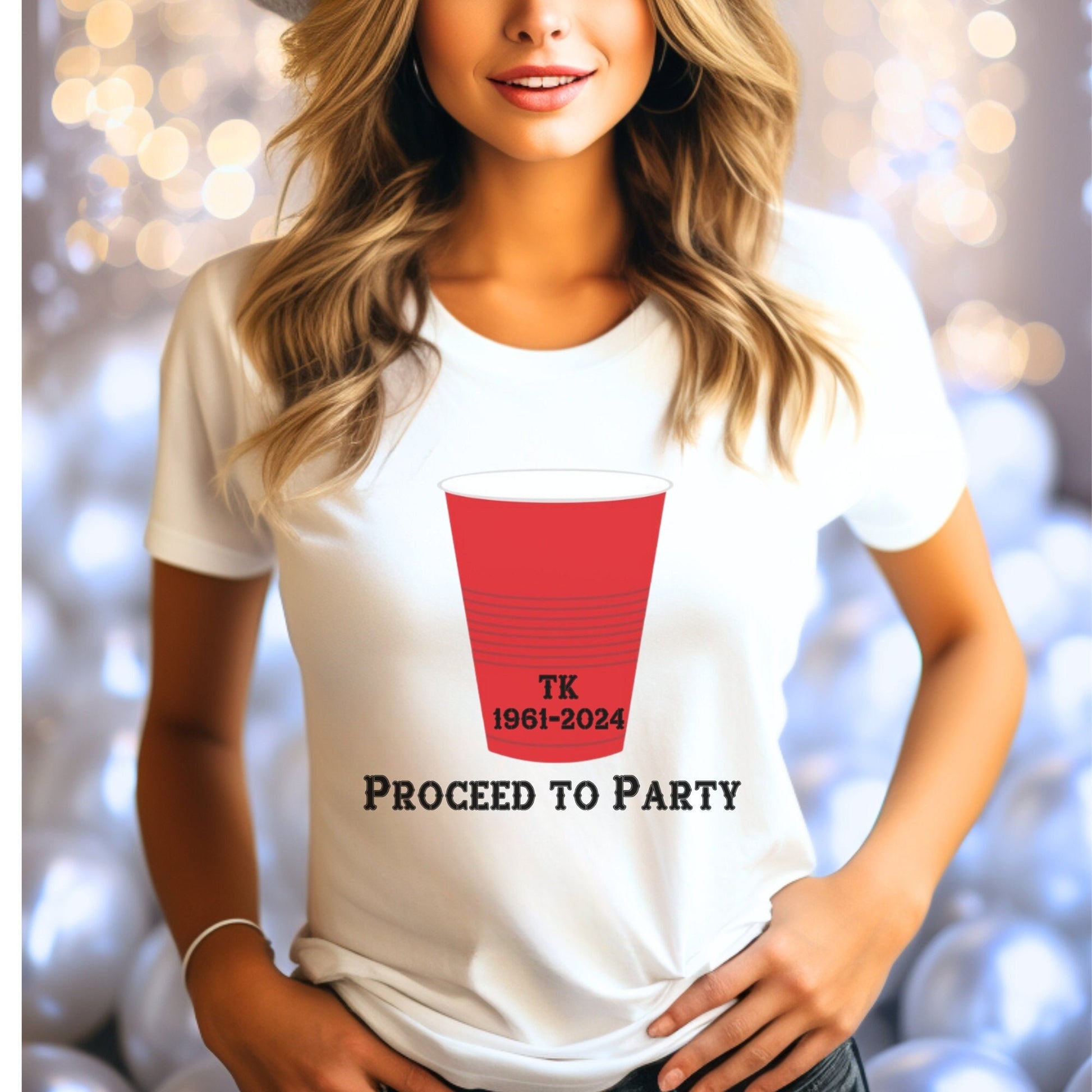 White T-shirt with a red party cup graphic and text. The cup has the initials TK and the years 1961-2024 printed on it